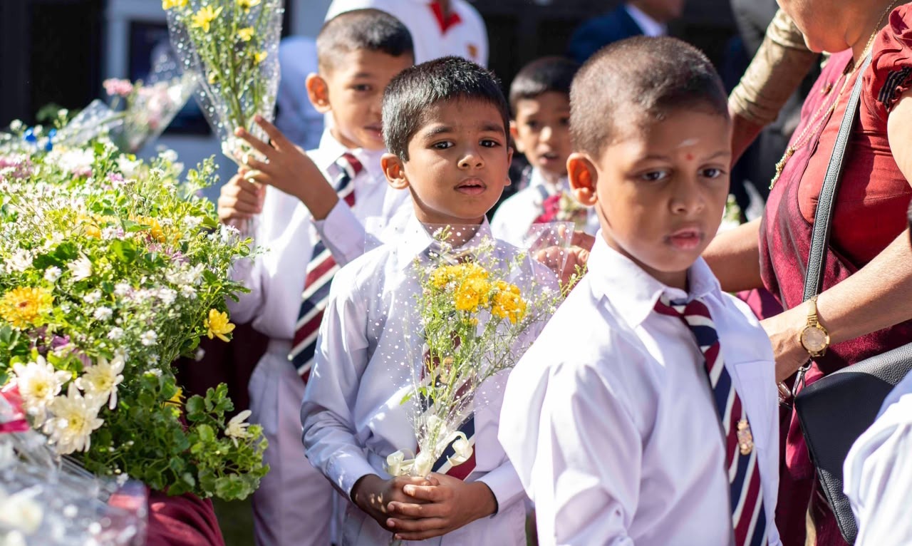 Students presenting flowers at Founder's Day